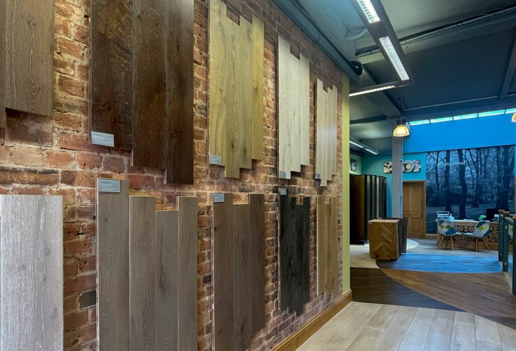 Broadleaf Timber's London Showroom Interior with a range of flooring planks on a brick wall.