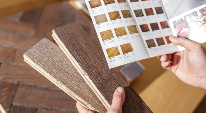 Solid wood flooring samples are compared with a wood flooring brochure.