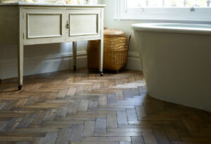 Solid worn oak vintage parquet flooring in a bathroom