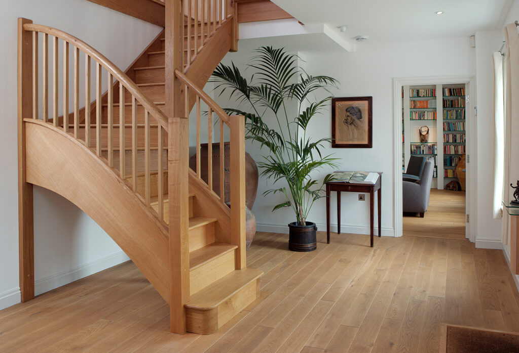 Feature Staircase with curved string & handrail and hallway ballustrade.