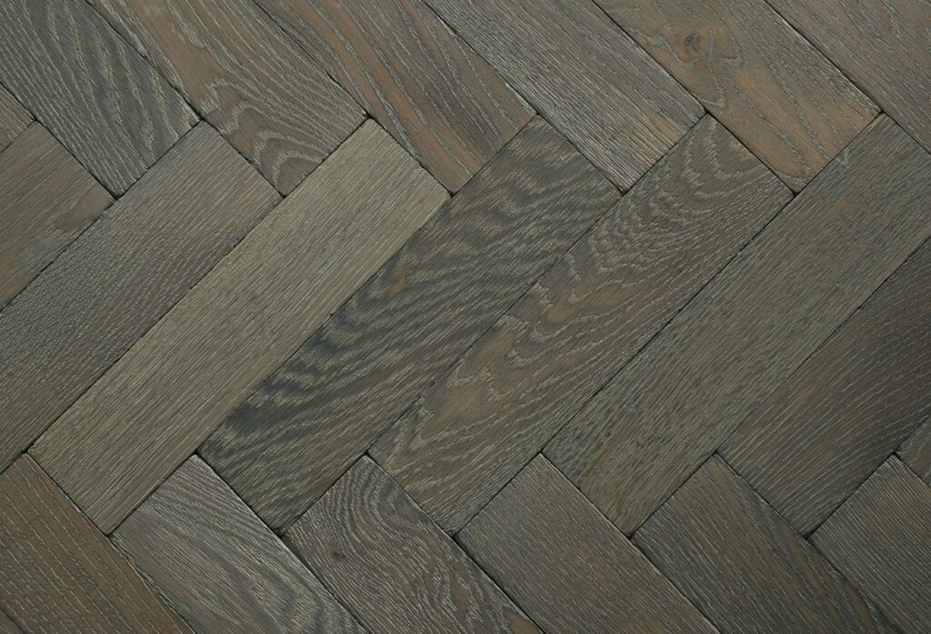 Herringbone patterned solid wood parquet flooring.