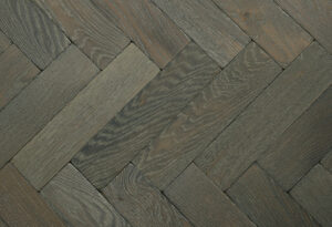 Herringbone patterned solid wood parquet flooring.