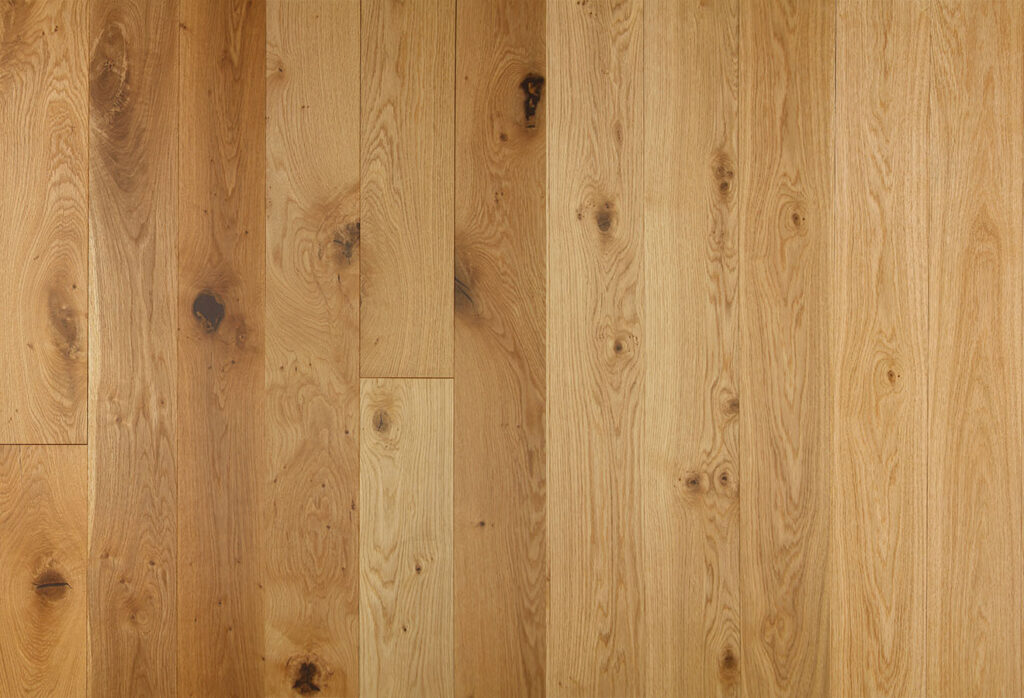 A selection of wooden flooring planks showing various wood grading.