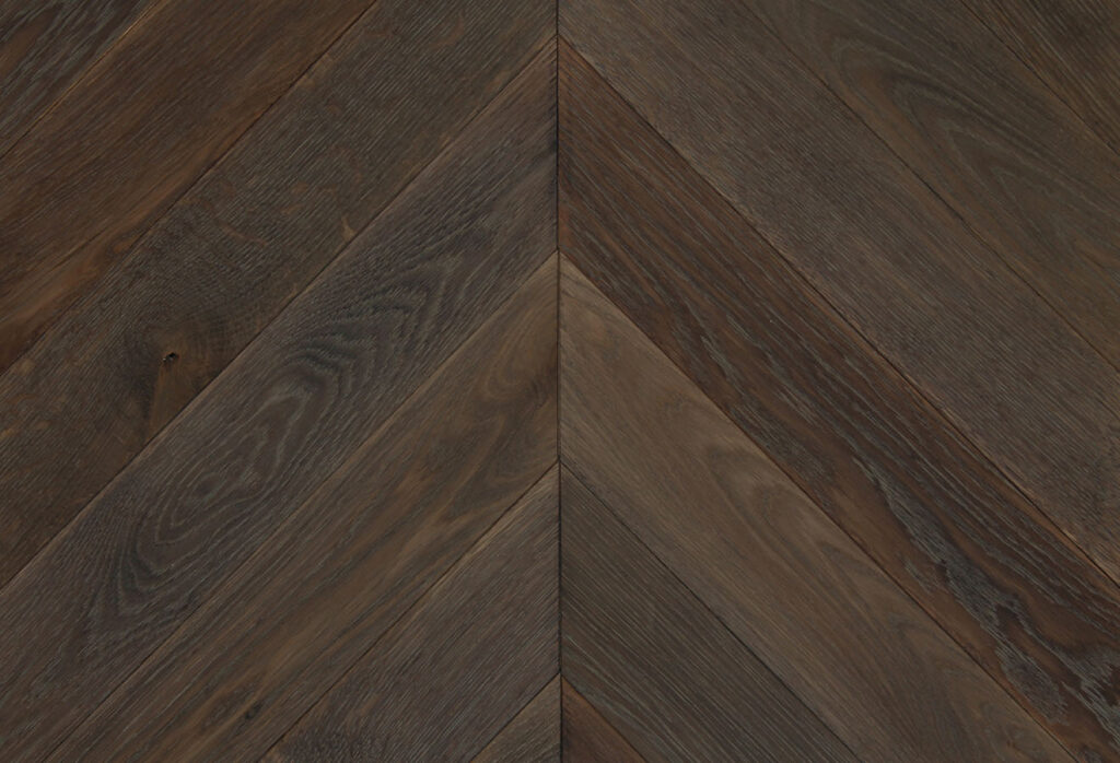 Dark coloured chevron patterned hardwood flooring by Broadleaf Timber.
