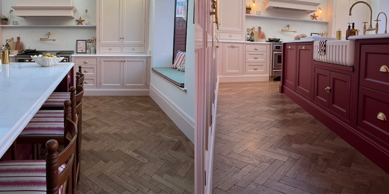 Rich toned real oak parquet flooring in a kitchen with burgundy and pink cabinets