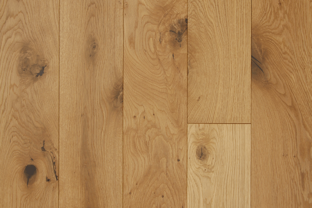Broadleaf oak plank floor with rustic grade. Visible grain and large knots.
