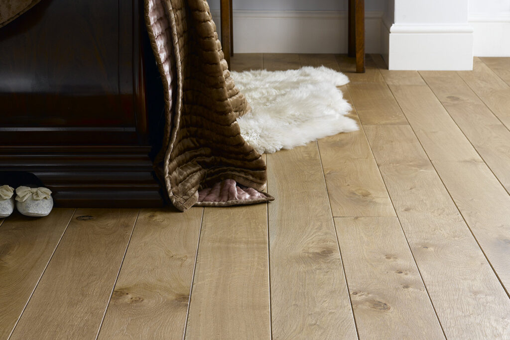 Broadleaf oak plank flooring in a bedroom.