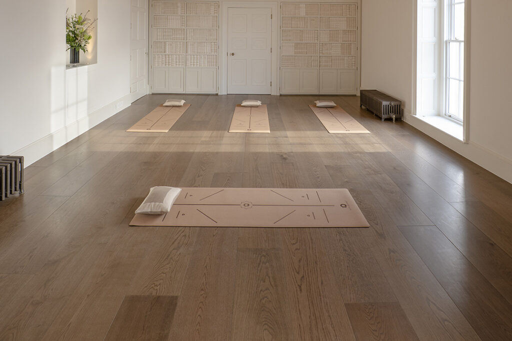 Wide board oak plank flooring in a yoga studio.