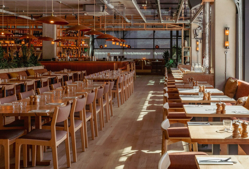 Nude oak plank flooring in a Caravan Restaurant, Manchester.